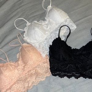 pink, black, and white bralettes